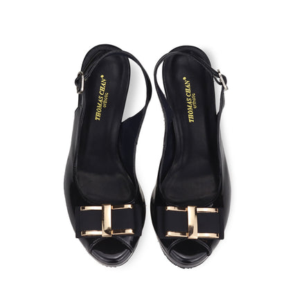 Front view of Thomas Chan Peep Toe Slingback Stiletto High Heels in black colour, showcasing one of the designs with a gold bow buckle.