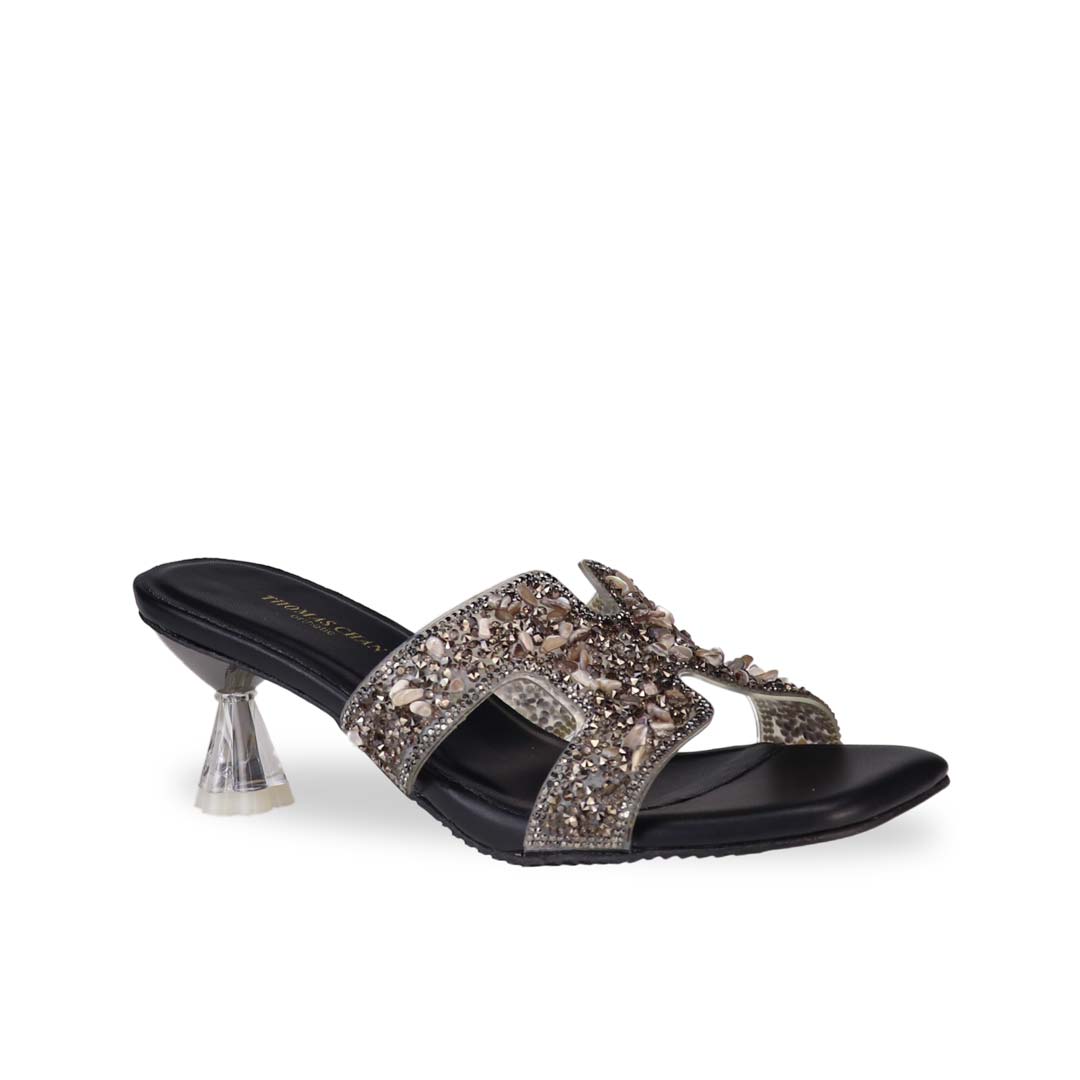 Diagonal view of Thomas Chan's Sparkle Jewel H-Strap Heeled Sandals in black, showcasing an elegant design and a uniquely crafted heel.