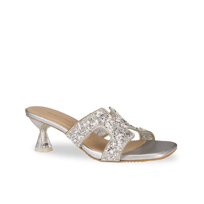 Diagonal view of Thomas Chan's Sparkle Jewel H-Strap Heeled Sandals in silver, showcasing an elegant design and a uniquely crafted heel.