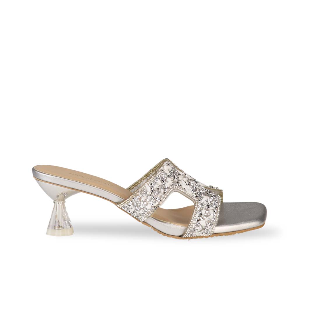 Side view of Thomas Chan's Sparkle Jewel H-Strap Heeled Sandals in silver, showcasing an elegant design and a uniquely crafted heel.