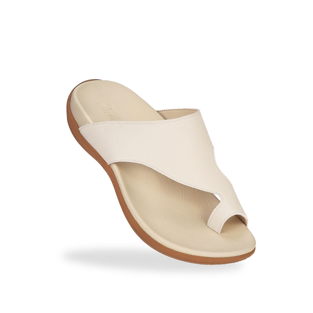 Diagonal view of Thomas Chan's Simple Toe Strap Flat Sandals in ivory, displaying an elegant design with an arch-support footbed.