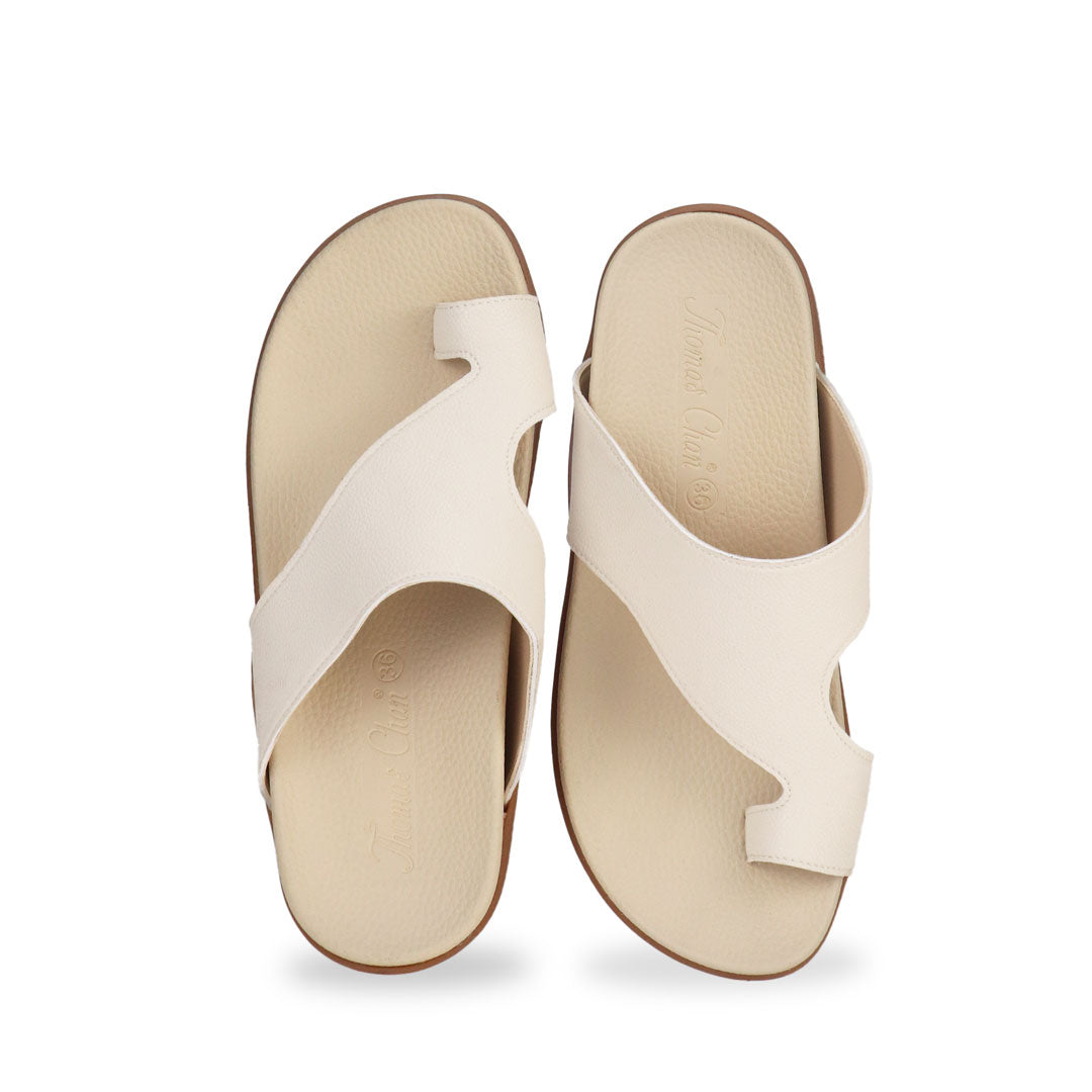 Front view of Thomas Chan's Simple Toe Strap Flat Sandals in ivory, displaying an elegant design with an arch-support footbed.