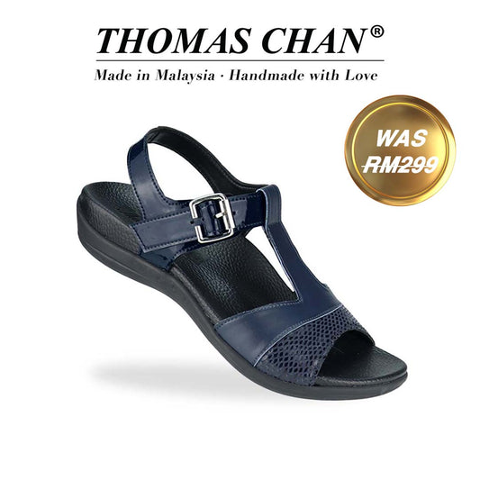 Diagonal view of Thomas Chan's Snake Print Ankle Strap Flat Sandals in blue, featuring a striking mix of snake print, matte, and patterned leather, paired with an adjustable ankle strap. Includes the Thomas Chan® orthotic soft arch-support footbed. The 'THOMAS CHAN®' brand is prominently displayed with 'Made in Malaysia · Handmade with Love' below. A gold and white banner highlights a special offer: 'Was RM299.'