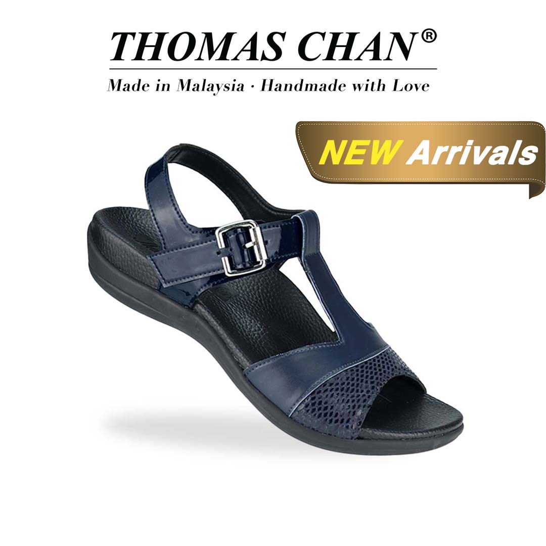 Diagonal view of Thomas Chan's Snake Print Ankle Strap Flat Sandals in blue, featuring a striking mix of snake print, matte, and patterned leather, paired with an adjustable ankle strap. Includes the Thomas Chan® orthotic soft arch-support footbed. The 'THOMAS CHAN®' brand is prominently displayed with 'Made in Malaysia · Handmade with Love' below. A gold and white banner highlights a special offer: 'New Arrival.'