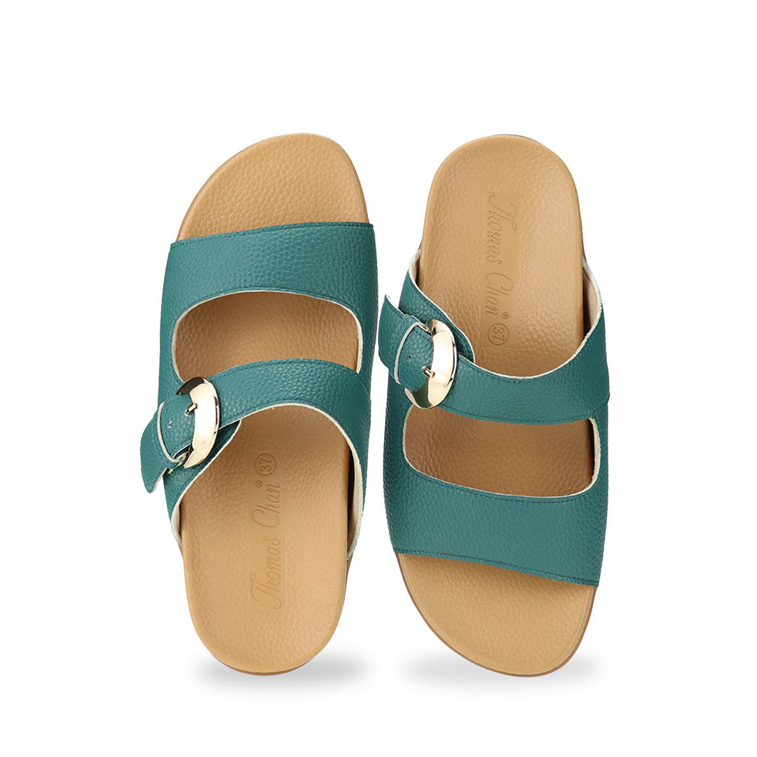 Front view of Great Coverage Buckle flat sandals in turquoise green, displaying an elegant design with an arch-support footbed.