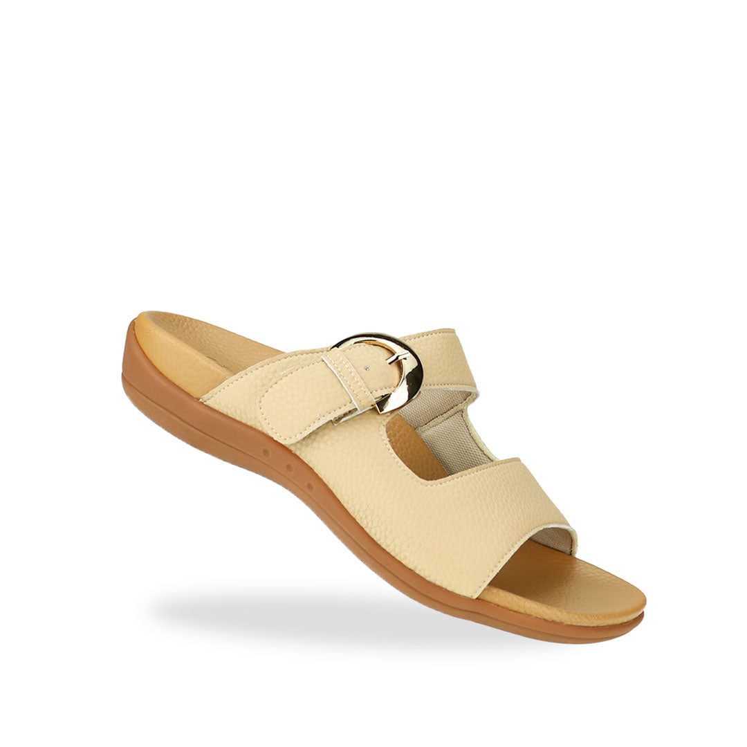 Diagonal view of Great Coverage Buckle flat sandals in mustard cream, displaying an elegant design with an arch-support footbed.