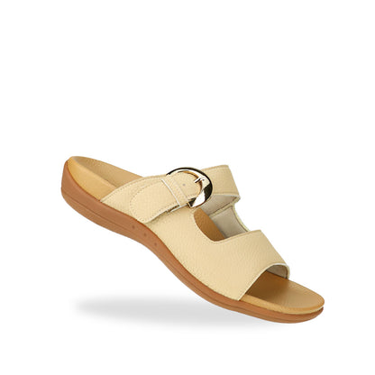 Diagonal view of Great Coverage Buckle flat sandals in mustard cream, displaying an elegant design with an arch-support footbed.