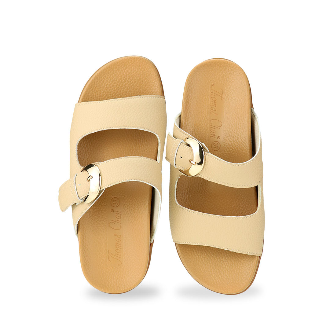 Front view of Great Coverage Buckle flat sandals in mustard cream, displaying an elegant design with an arch-support footbed.