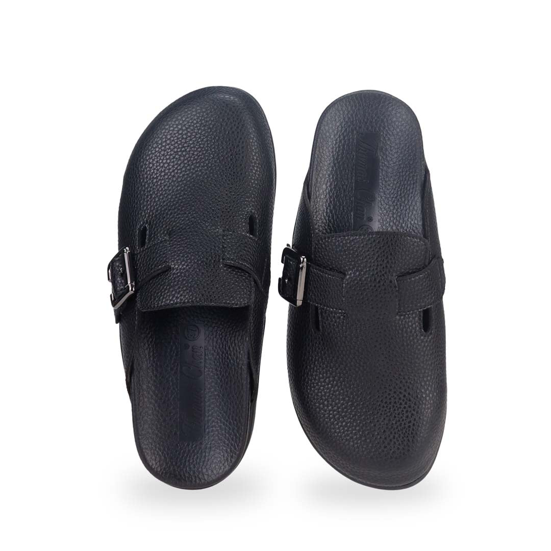 Front view of Thomas Chan's closed-toe buckle sandals in black colour with pebbled texture, the sandals feature a sleek design with a black buckle strap across the top and a black inner lining, with arch-support footbed.