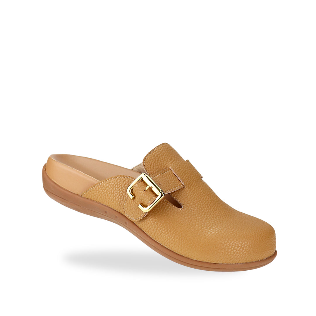 Diagonal view of Thomas Chan's closed-toe buckle sandals in tan colour with pebbled texture, the sandals feature a sleek design with a silver buckle strap across the top and a foam inner lining, with arch-support footbed.