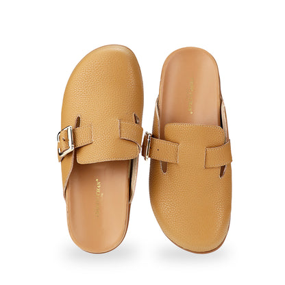 Front view of Thomas Chan's closed-toe buckle sandals in tan colour with pebbled texture, the sandals feature a sleek design with a silver buckle strap across the top and a foam inner lining, with arch-support footbed.