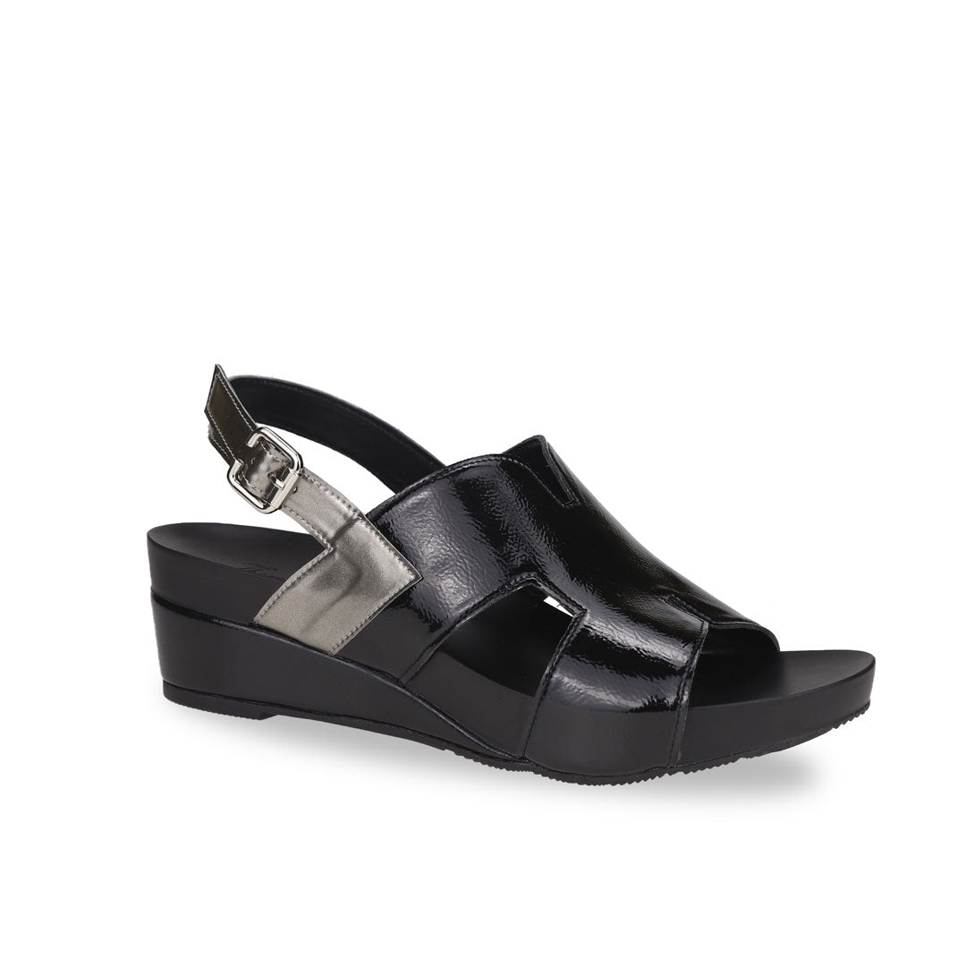 Diagonal view of Thomas Chan H-Strap with Slingback Low Wedge Sandals in black, featuring a mixture of silver patent at the slingback, ensuring comfortable wear and an easy walking experience.