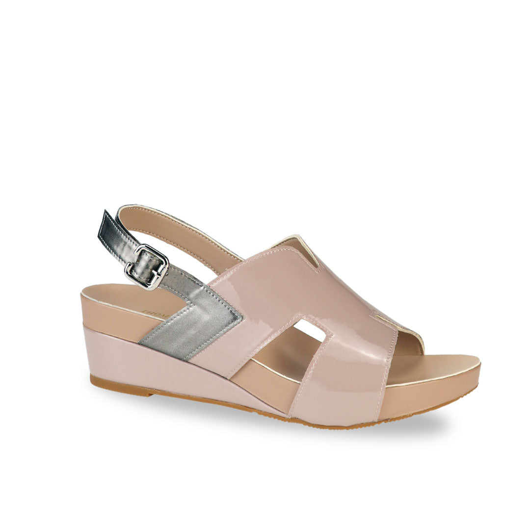 Diagonal view of Thomas Chan H-Strap with Slingback Low Wedge Sandals in light taupe, featuring a mixture of silver patent at the slingback, ensuring comfortable wear and an easy walking experience.