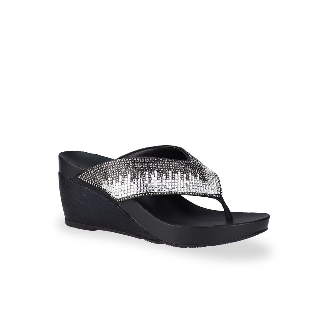 Diagonal view of Thomas Chan Suede Rhinestone Wedge Flip Flops in black colour: Elevate your casual look with a touch of sparkle and comfort. These chic wedge flip flops, adorned with rhinestones, are perfect for adding a hint of glamour to your summer ensemble.