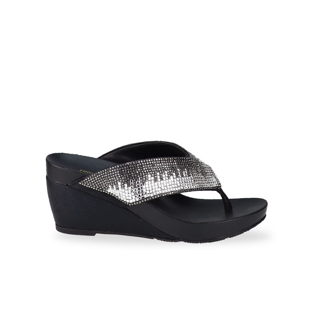 Side view of Thomas Chan Suede Rhinestone Wedge Flip Flops in black colour: Elevate your casual look with a touch of sparkle and comfort. These chic wedge flip flops, adorned with rhinestones, are perfect for adding a hint of glamour to your summer ensemble.