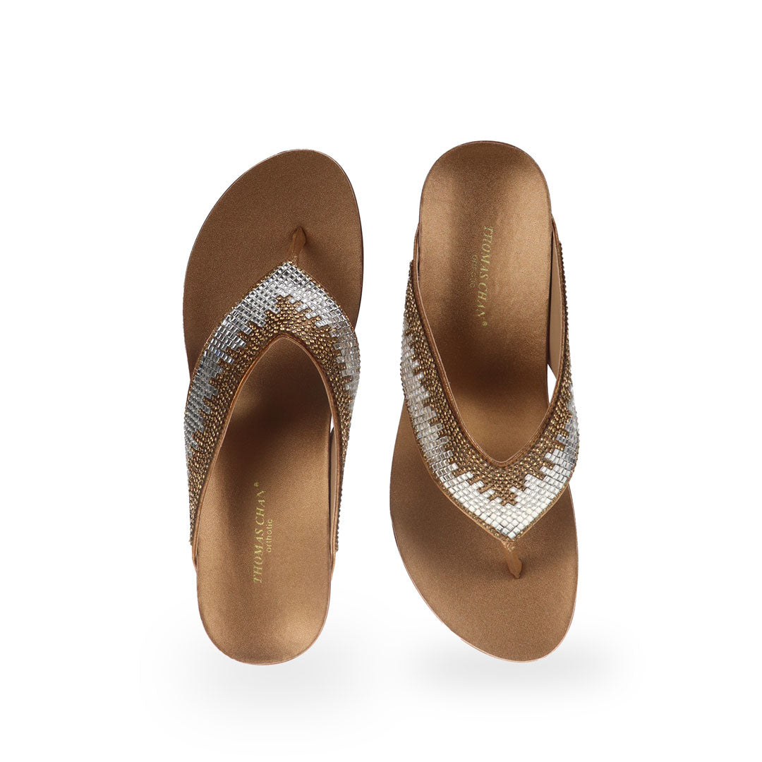 Front view of Thomas Chan Suede Rhinestone Wedge Flip Flops in bronze colour: Elevate your casual look with a touch of sparkle and comfort. These chic wedge flip flops, adorned with rhinestones, are perfect for adding a hint of glamour to your summer ensemble.