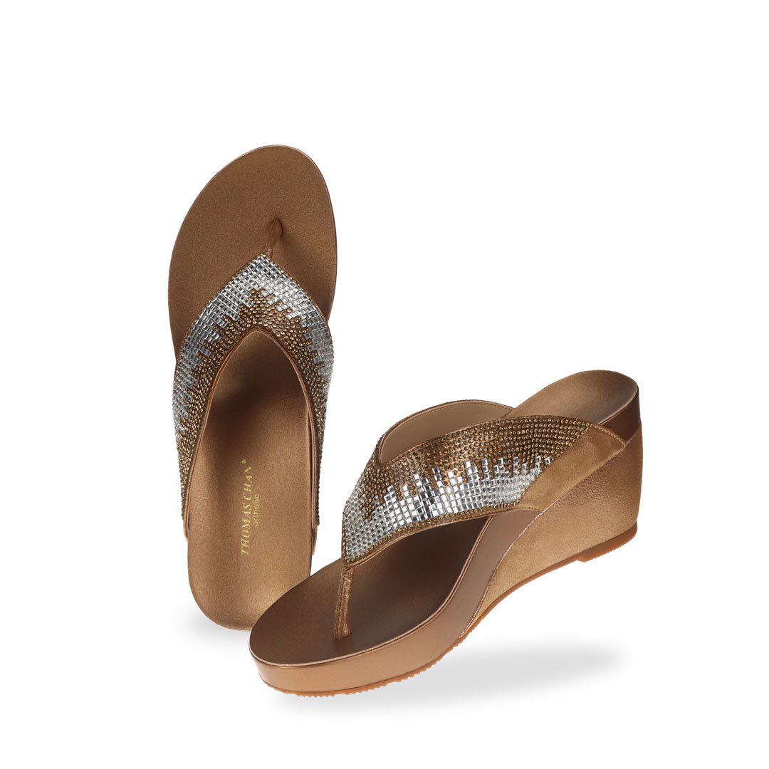 Full view of Thomas Chan Suede Rhinestone Wedge Flip Flops in bronze colour: Elevate your casual look with a touch of sparkle and comfort. These chic wedge flip flops, adorned with rhinestones, are perfect for adding a hint of glamour to your summer ensemble.