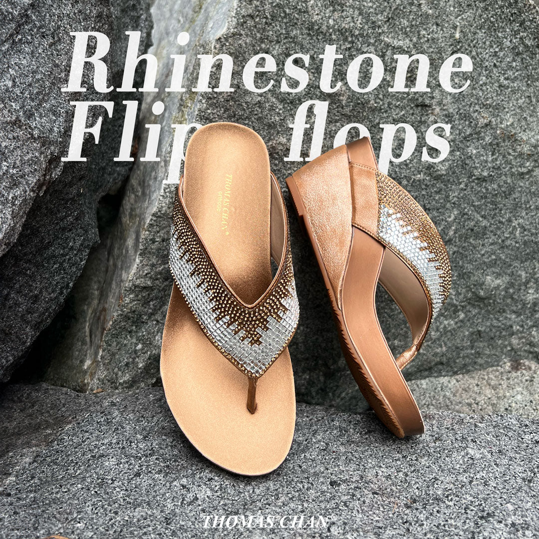 Thomas Chan's Suede Rhinestone Wedge Flip Flops in bronze displaying on the rock, featuring a 3-inch wedge heel, these sandals provide exceptional comfort with the integrated Thomas Chan® Orthotic Arch-Legance footbed.