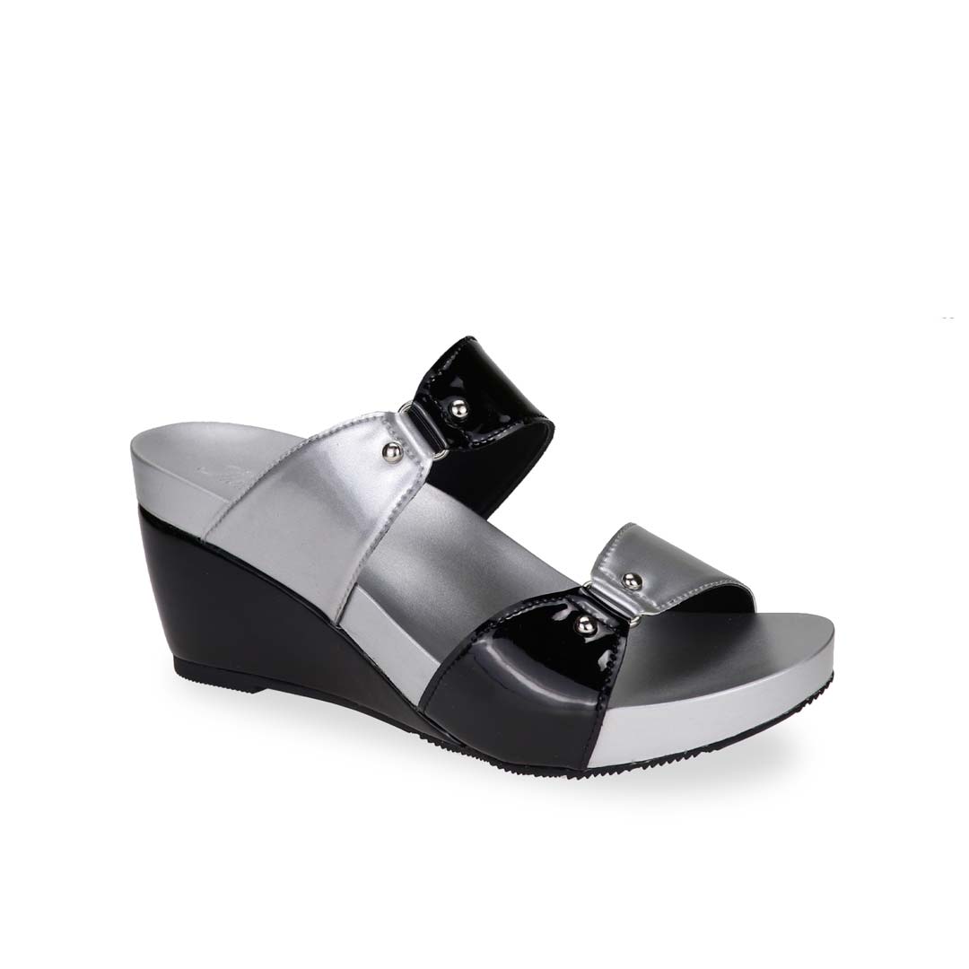 Diagonal view of silver and black colour Thomas Chan bold Yin Yang contrast colour matching studded high wedge sandals with orthotic insoles.