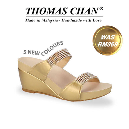 Thomas Chan Multi-Row Diamond Wedge Sandals in pattern gold, featuring multi-row diamond decoration, and arch-support footbed. "THOMAS CHAN®" brand displayed with "Made in Malaysia · Handmade with Love" below. Gold and white banner highlights special offer: "Was RM269" "5 NEW COLOURS"