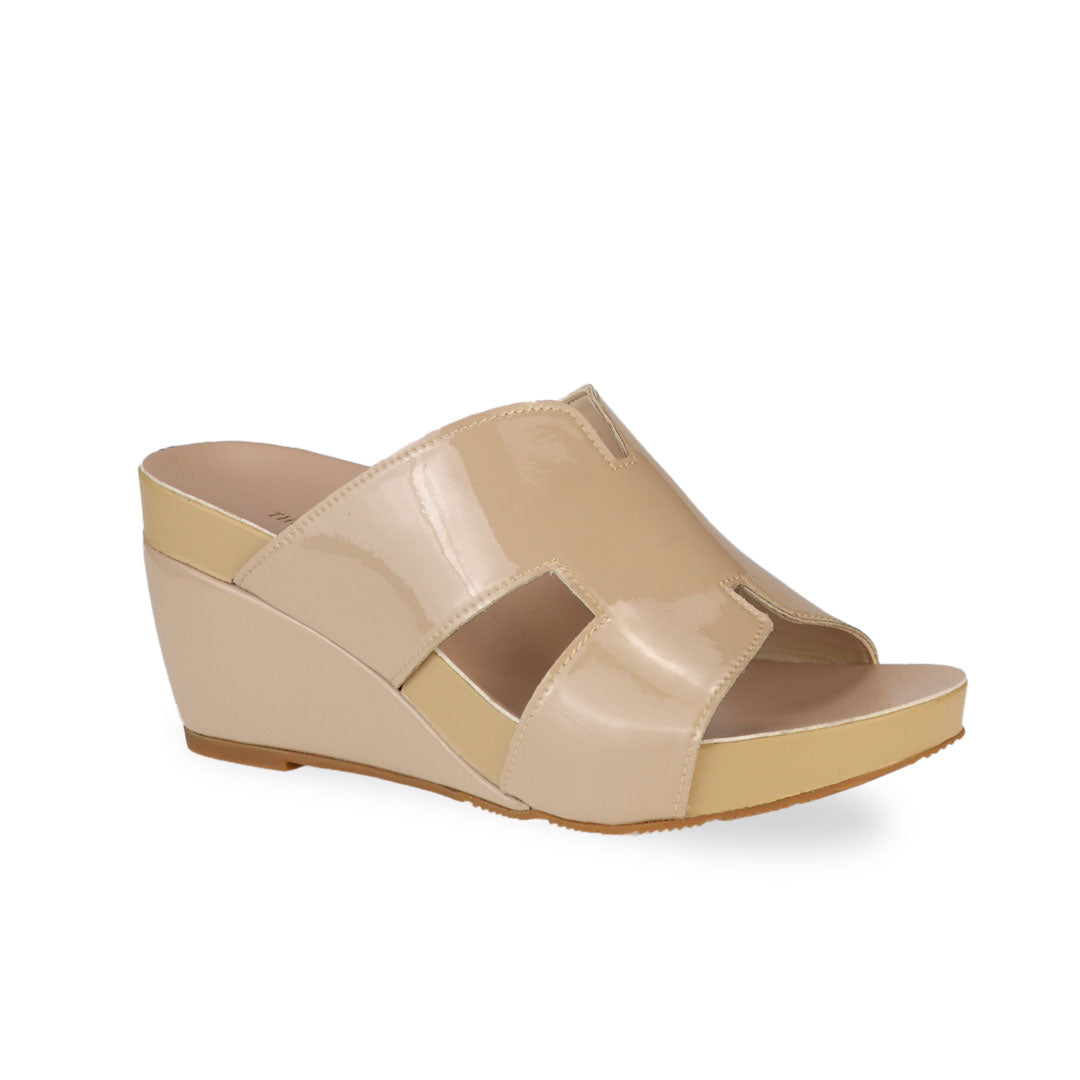 Diagonal view of Thomas Chan cream H-strap wedge sandals, featuring a simple, elegant design with comfortable wedges.