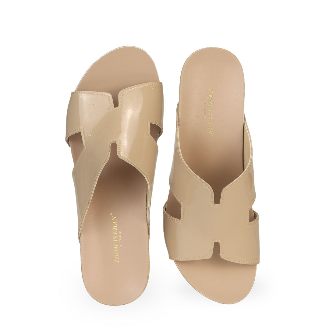 Front view of Thomas Chan cream H-strap wedge sandals, featuring a simple, elegant design with comfortable wedges.