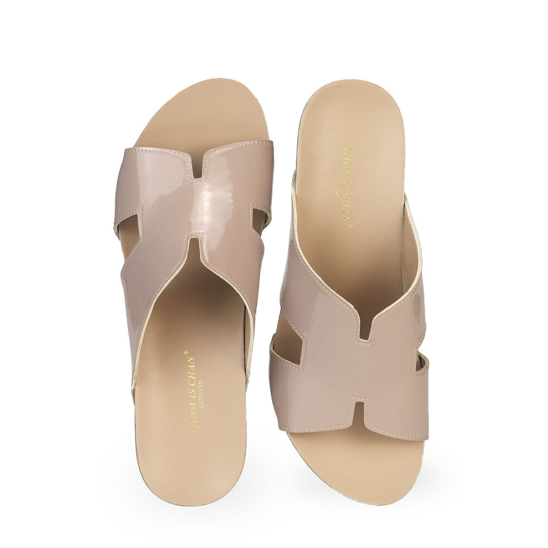 Front view of Thomas Chan light taupe H-strap wedge sandals, featuring a simple, elegant design with comfortable wedges.