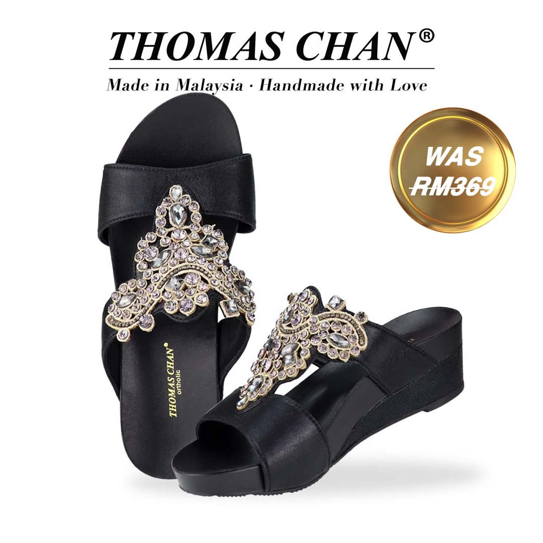 Thomas Chan's Vintage Rhinestone Low Wedge Sandals in black, adorned with vintage-inspired rhinestone detailing ,and an arch-support footbed. "THOMAS CHAN®" brand displayed with "Made in Malaysia · Handmade with Love" below. Gold and white banner highlights special offer: "Was RM369."