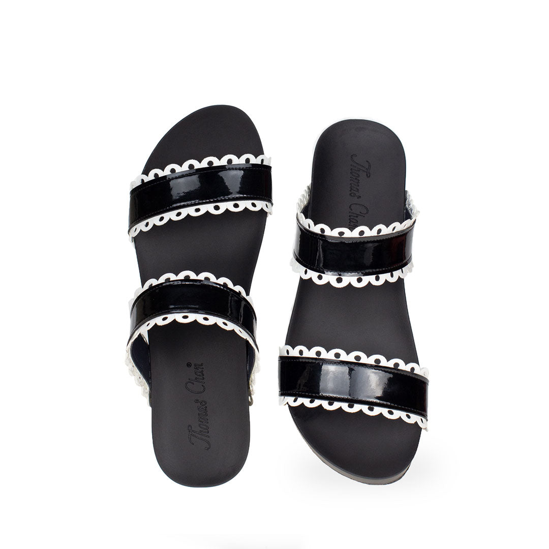 front view of comfortable cute Thomas Chan handmade slide sandals in black and white flower cutout strappy design