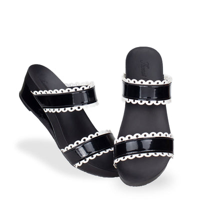 full view of comfortable cute Thomas Chan handmade slide sandals in black and white flower cutout strappy design