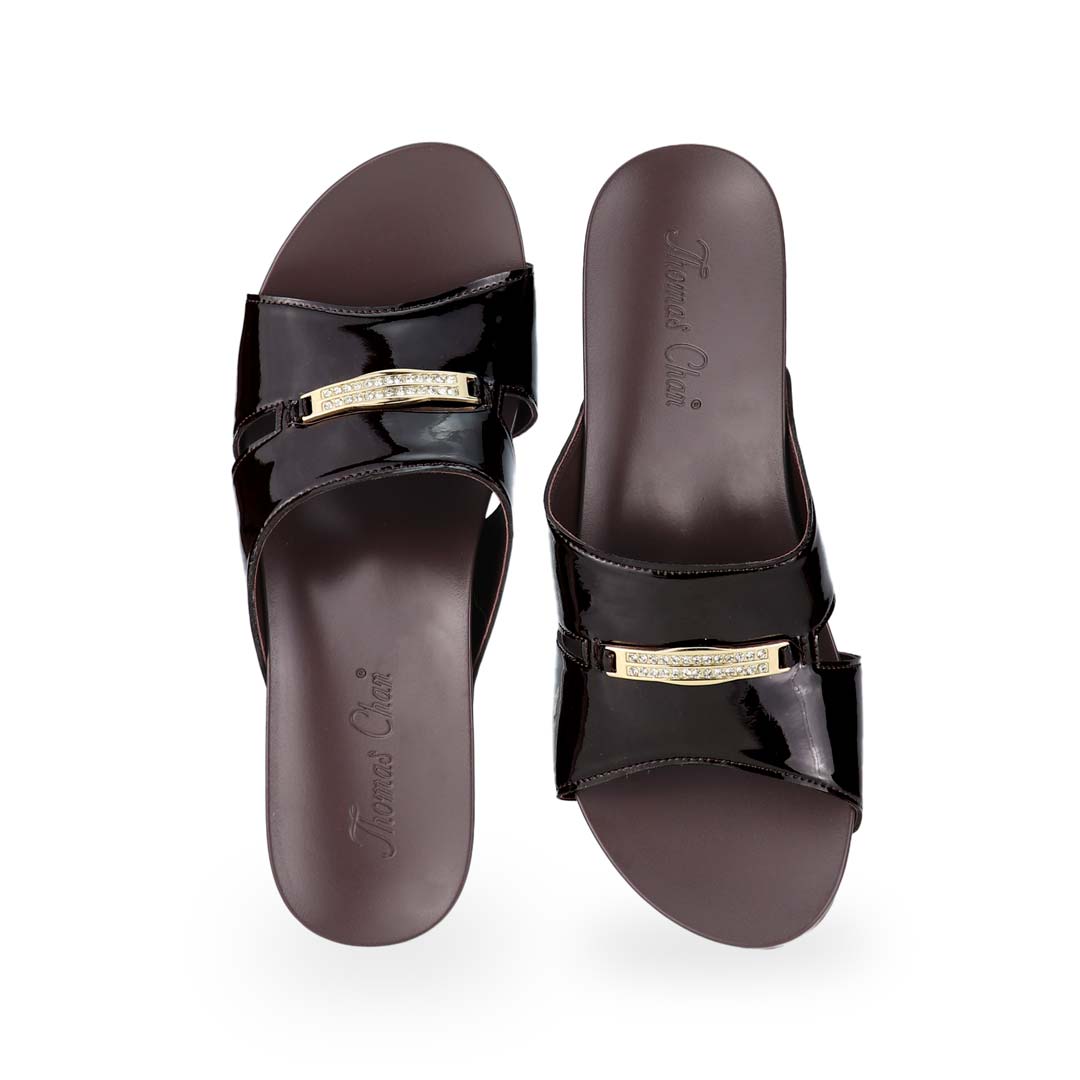 Front view of Thomas Chan's Mini Charm Low Wedge Sandals in dark chocolate, featuring small charm detail, a coverage design, and an arch-support footbed.