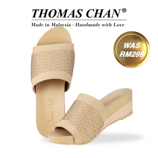 Thomas Chan's Comfy Elegant Low Wedges in cream, featuring rhinestone accents, a coverage design, and an arch-support footbed. "THOMAS CHAN®" brand displayed with "Made in Malaysia · Handmade with Love" below. Gold and white banner highlights special offer: "Was RM299."