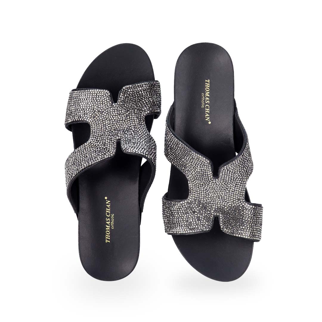 Front view of Thomas Chan's H-strap Glamour Stone Low Wedges in black, adorned with glamour rhinestone detailing ,and an arch-support footbed.