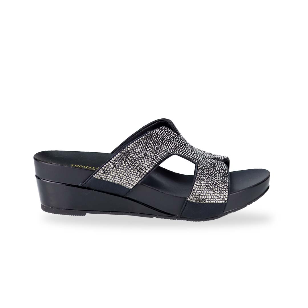 Side view of Thomas Chan's H-strap Glamour Stone Low Wedges in black, adorned with glamour rhinestone detailing ,and an arch-support footbed.