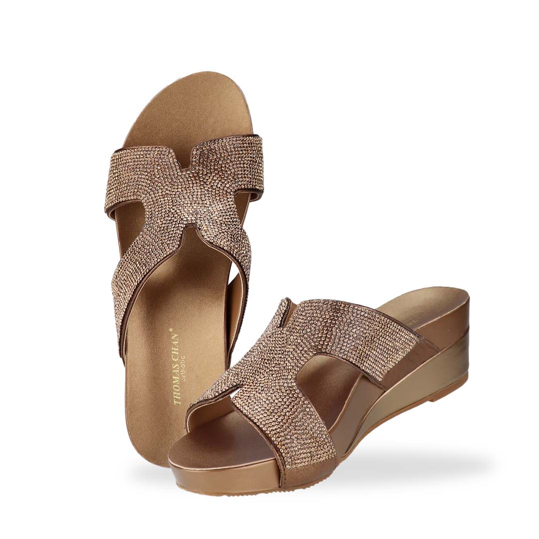 Full view of Thomas Chan's H-strap Glamour Stone Low Wedges in bronze, adorned with glamour rhinestone detailing ,and an arch-support footbed.