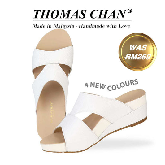 Thomas Chan's Pebble Lychee Everyday Low Wedge Slides in white, featuring an arch-support footbed. The "THOMAS CHAN®" brand is displayed with "Made in Malaysia · Handmade with Love" below. A gold and white banner highlights a special offer: "Was RM269." "4 New Colours"