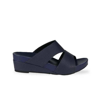 Side view of Thomas Chan's Pebble Lychee Everyday Low Wedge Slides in dark blue, featuring an arch-support footbed. 