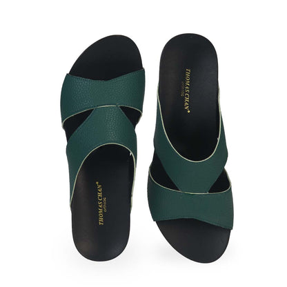 Front view of Thomas Chan's Pebble Lychee Everyday Low Wedge Slides in dark green, featuring an arch-support footbed. 