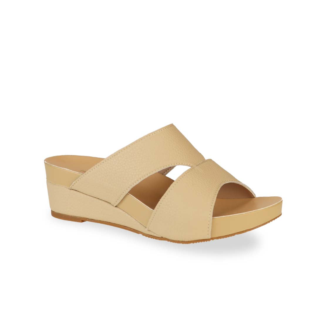 Diagonal view of Thomas Chan's Pebble Lychee Everyday Low Wedge Slides in mustard cream, featuring an arch-support footbed. 