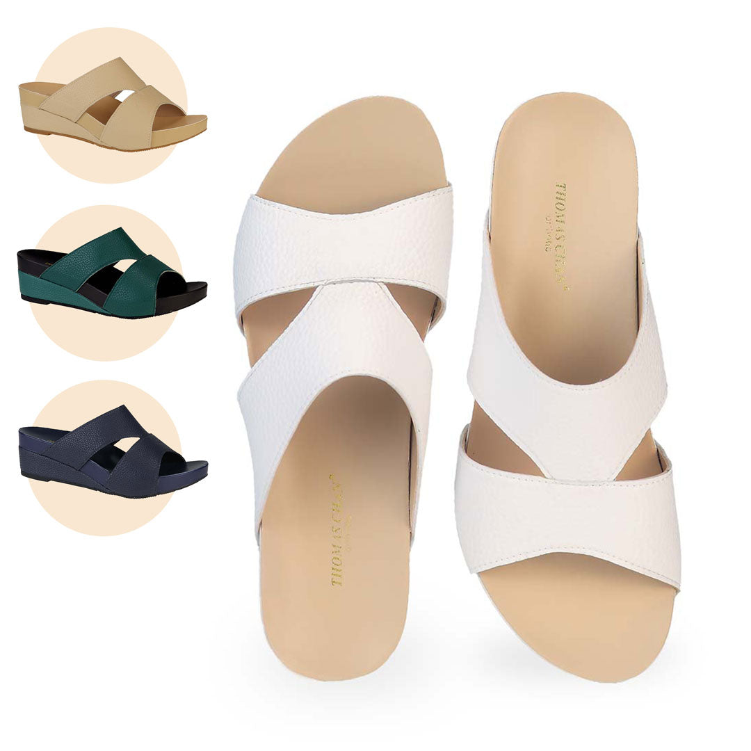 Thomas Chan's Pebble Lychee Everyday Low Wedge Slides in pastel white, featuring an arch-support footbed. Also available in mustard cream, dark green, and navy blue.