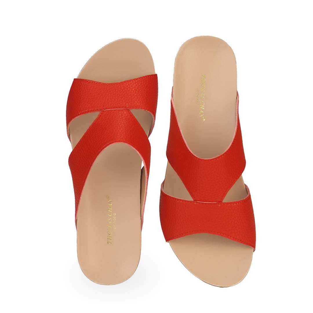 Front view of Thomas Chan's Pebble Lychee Everyday Low Wedge Slides in red, featuring an arch-support footbed. 