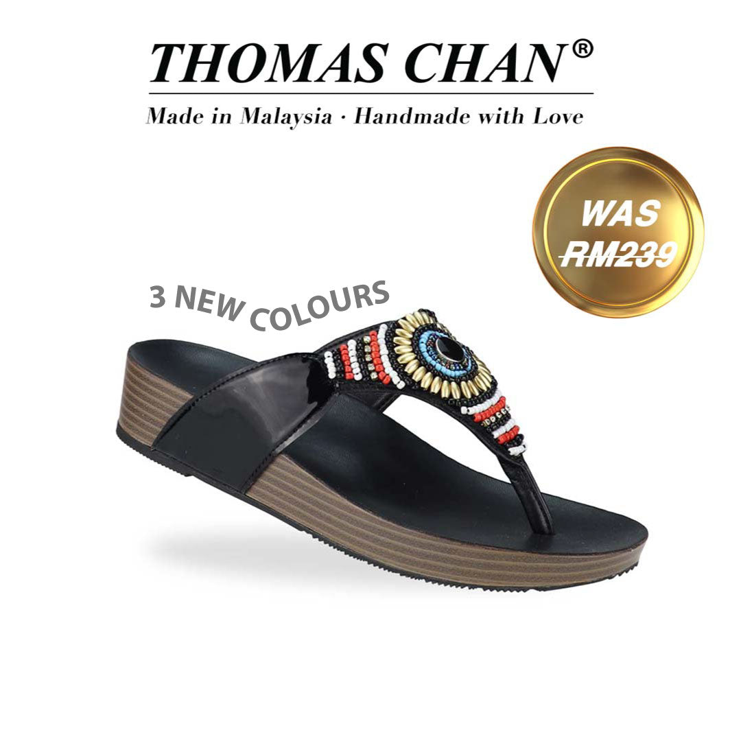 Diagonal view of Thomas Chan's Boho Beaded Flatform Flip-Flops in black, showcasing the boho beaded design and LiteStep flatform footbed. The 'THOMAS CHAN®' brand is displayed below with 'Made in Malaysia · Handmade with Love.' A gold and white banner highlights a special offer: 'Was RM239' and '3 new colours.'