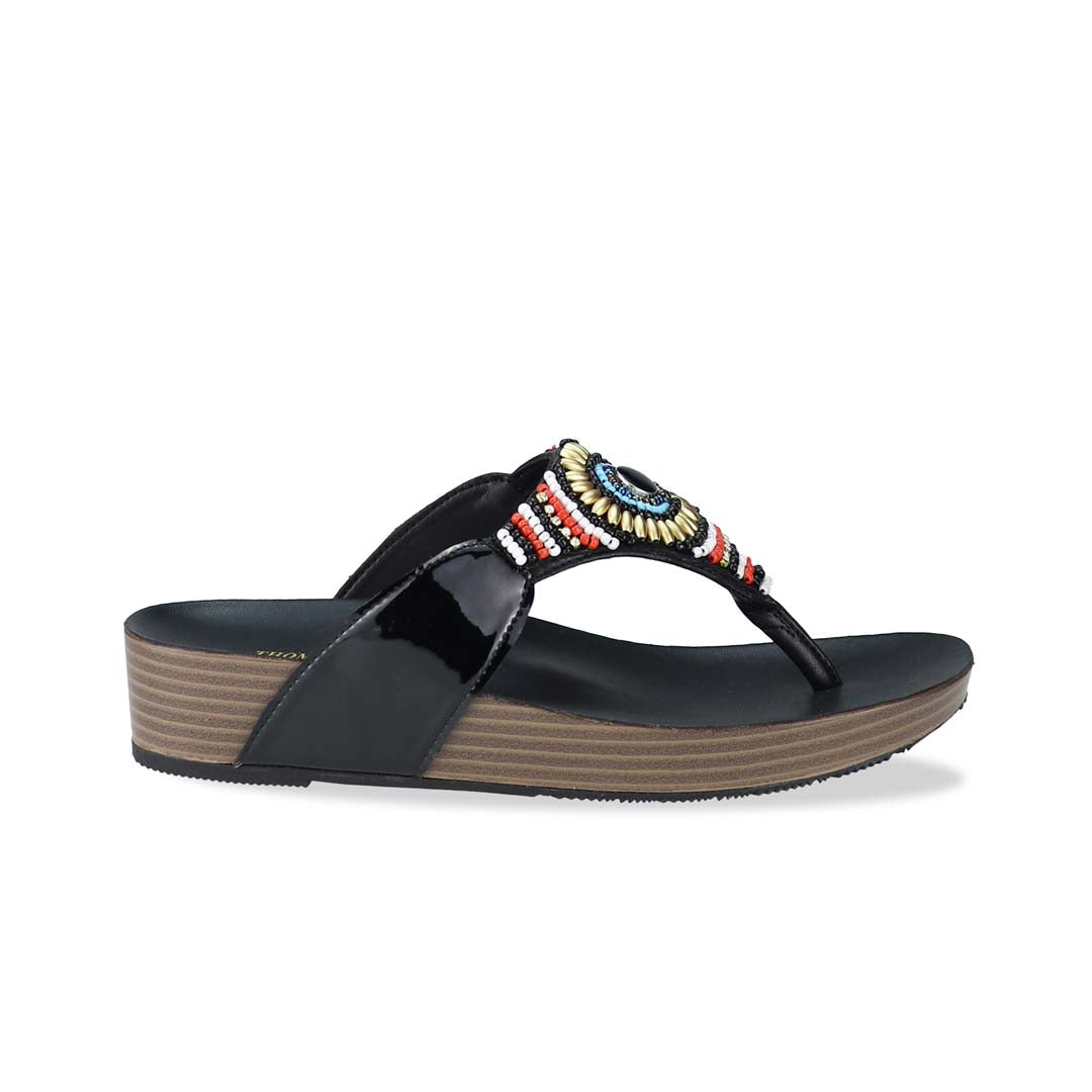 Side view of Thomas Chan's Boho Beaded Flatform Flip-Flops in black, showcasing the boho beaded design and LiteStep flatform footbed. The image highlights the flip-flops' boho beaded accents and casual style.