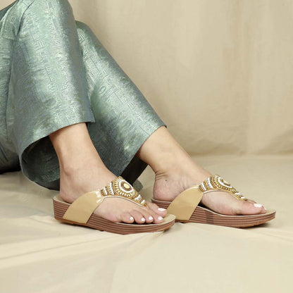 A model wearing cream Thomas Chan's Boho Beaded Flatform Flip-Flops with a 3cm flatform, paired with green ethnic dress. Set against a cream-colored backdrop, highlighting the flip-flops' boho beaded design and casual style.