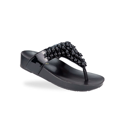 Diagonal view of Thomas Chan's Pearl Tassel Flip-Flops from the LiteStep Collection. The sandals feature a glossy black strap adorned with pearl tassel embellishments, paired with a comfortable flatform sole.