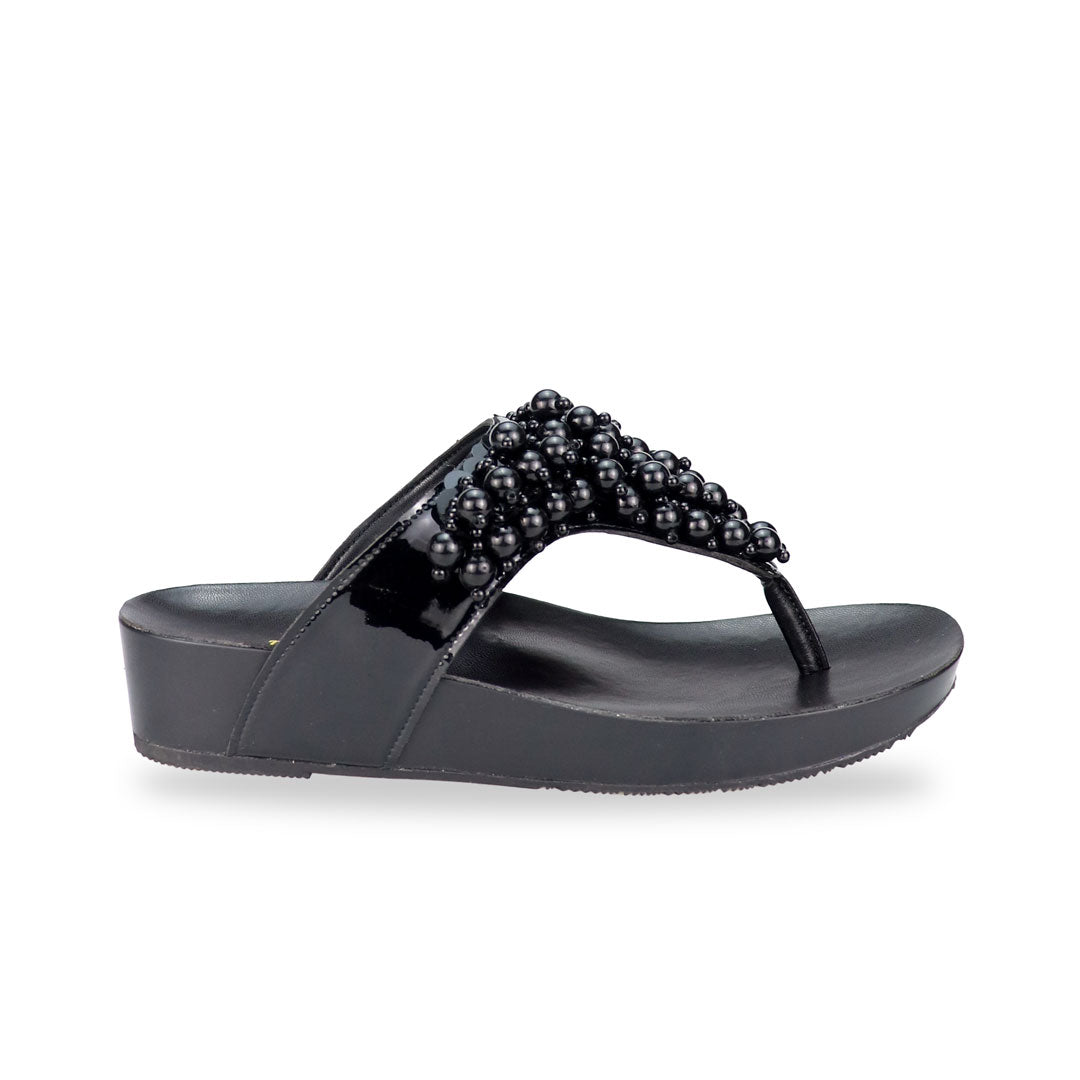 Side view of Thomas Chan's Pearl Tassel Flip-Flops from the LiteStep Collection. The sandals feature a glossy black strap adorned with pearl tassel embellishments, paired with a comfortable flatform sole.