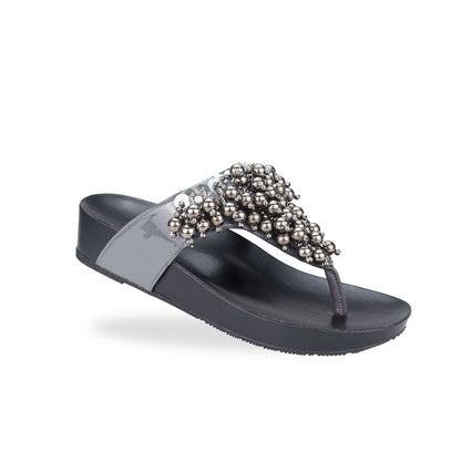 Diagonal view of Thomas Chan's Pearl Tassel Flip-Flops from the LiteStep Collection. The sandals feature a glossy grey strap adorned with pearl tassel embellishments, paired with a comfortable flatform sole.