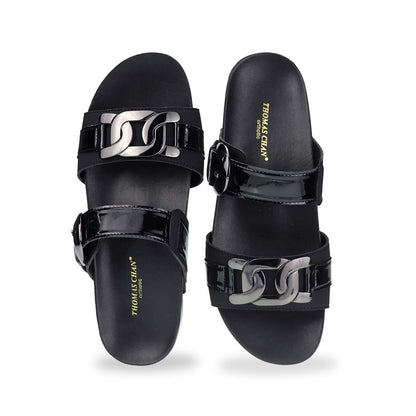 Front view of Thomas Chan’s Metallic Duo-Strap Adjustable Sandals in black, showcasing sleek metallic straps, an adjustable buckle for a perfect fit, and a LiteStep flatform footbed for added comfort.