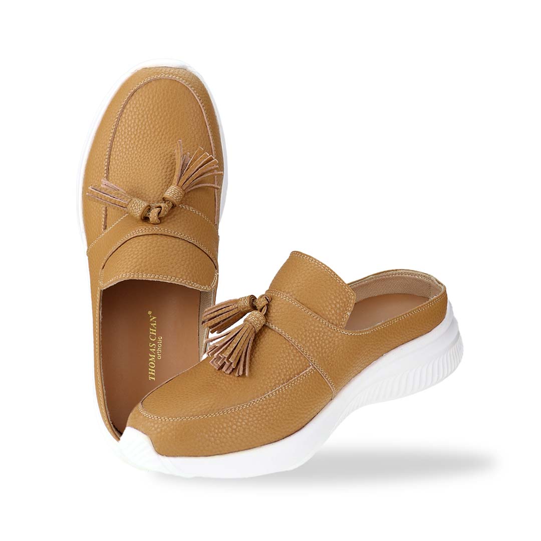 Full view of Thomas Chan Feather-Light Tassel Slide-On Loafers in camel, featuring a tassel bell design and a comfortable cushioned footbed.