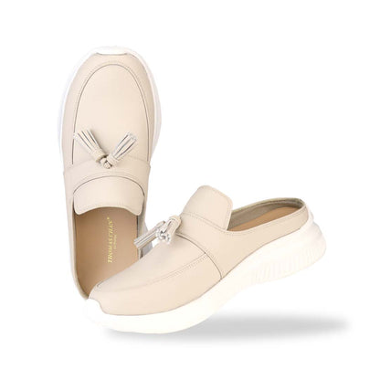 Full view of Thomas Chan Feather-Light Tassel Slide-On Loafers in ivory, featuring a tassel bell design and a comfortable cushioned footbed.